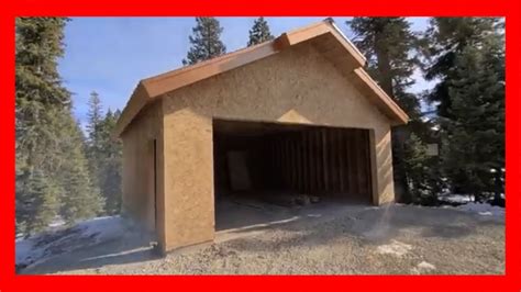 Framing a Garage setting trusses with case TV 450 Skid Steer